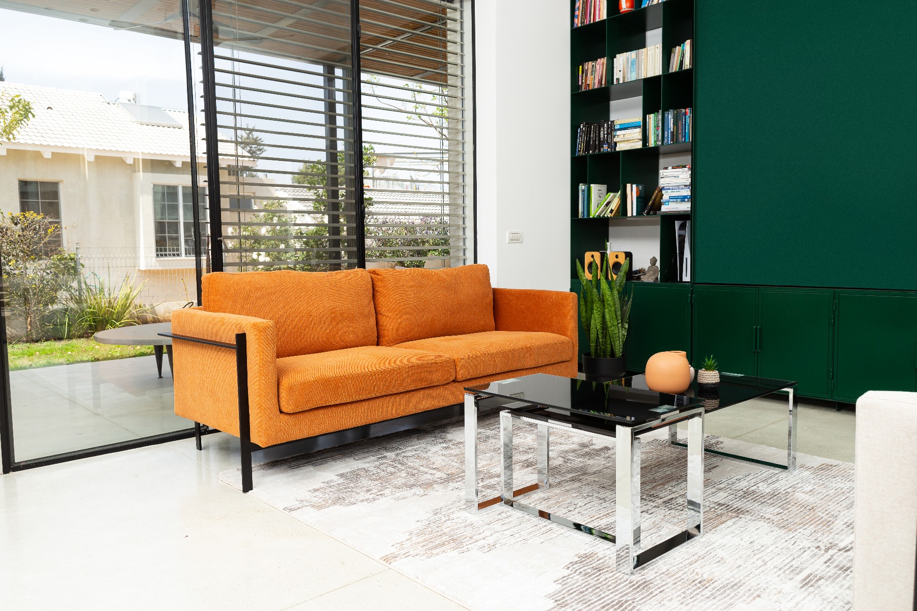 ספה תלת מושבית מדגם דסטיני בצבע כתום עם שולחן מעוצב מזכוכית שחורה מדגם